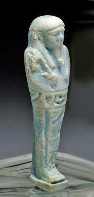 Egyptian Faience Ushabti, Late Kingdom: Egypt, 26th Dynasty, Ca 662 to 554 BCE. Pale aqua faience shabti with hieroglyphs inscribed around body. 4-3/4”H. Provenance: Ex-Glenn Woods Collection, Dallas, TX. All items in this auction are le