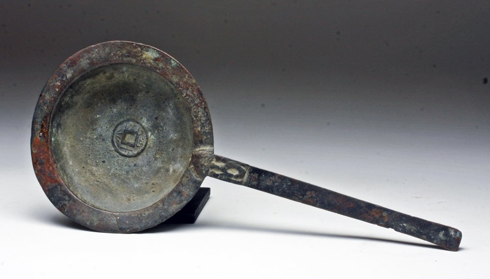 Chinese Zhou / Qin Dynasty Bronze Ladle: China, Zhou to Qin Dynasty, Ca 700 to 207 BCE. Bronze ladle - which on its own is wonderful, but not necessarily unique. What makes this extraordinary, stamped in the center is a good-luck charm very 