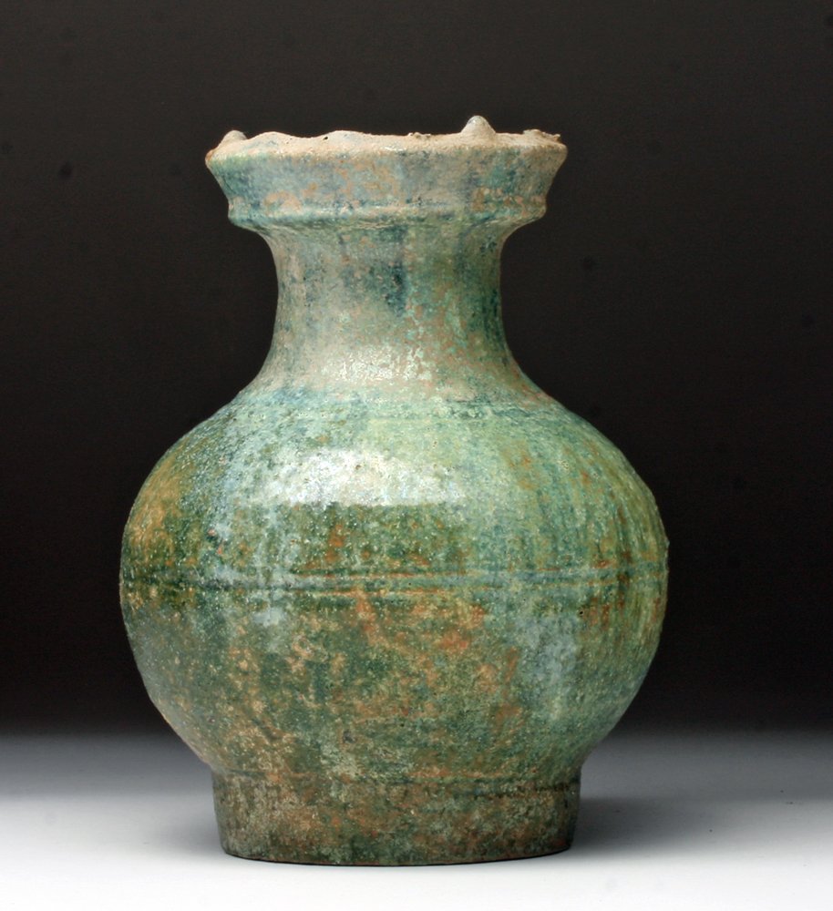 Chinese Han Dynasty Green Glazed Vase: China, Han Dynasty, ca. 206 BCE - 220 CE. Beautiful ceramic vase with portions of glaze still visible. Bulbous body contours into a thin neck and flared rim. Vessel was dipped in a vibrant glaze with 