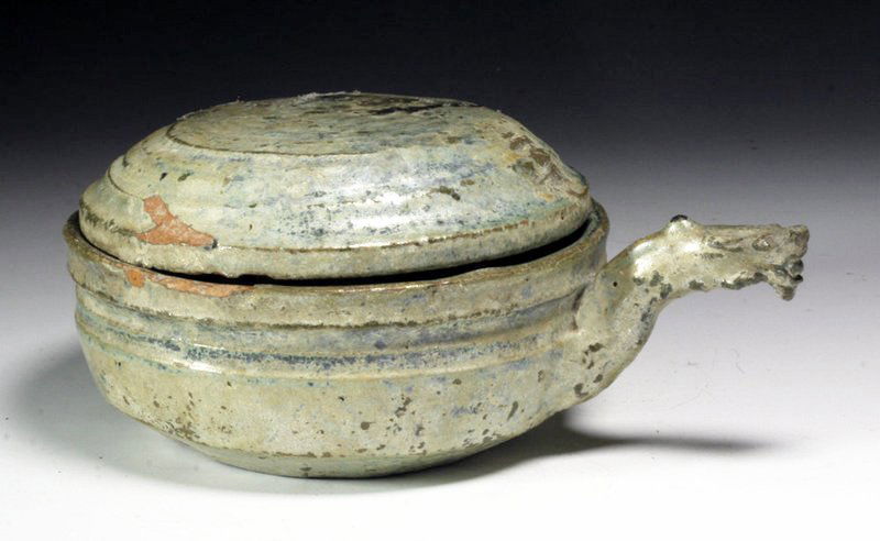 Chinese Han Dynasty Green Glazed Dragon Dipper: China, Han Dynasty, Ca. 220 BCE - 206 CE. Green glazed pottery ladle with dragon handle and cover. Dragon is depicted with mouth open and tongue sticking out. Beautiful iridescence has formed over gla
