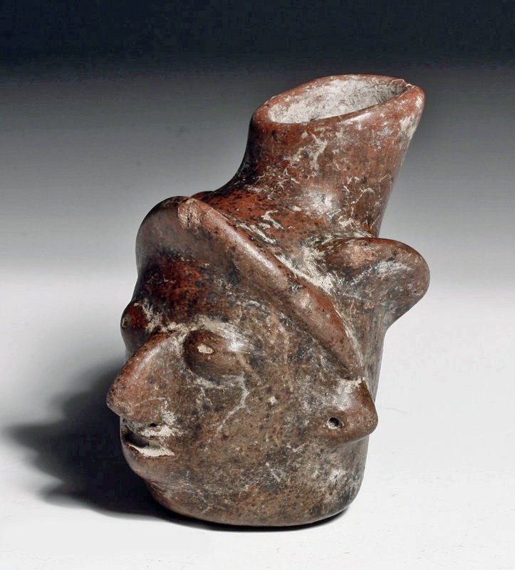 Colima Miniature Pottery Head Vessel.: West Mexico, Colima culture, Ca. 200 BCE to 200 CE. Small vessel in the form of a human head of the variety most usually many times larger. Covered in brown pigment and root marks, small spout at the 