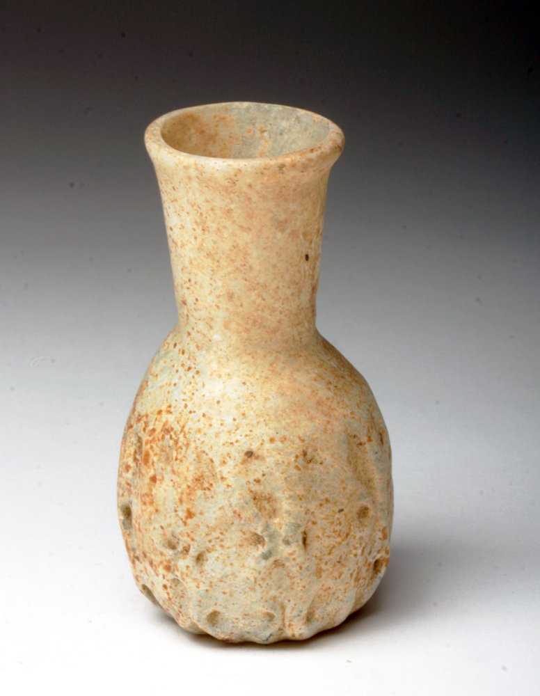 Roman Glass Sack-Shaped Jar: Roman Empire, Ca 200 to 350 CE. Glass vessel in sack form in milky glass, numerous dimples and folds in lower section. 3" H. Provenance: Ex-private Florida Collection, acquired before 2000. All items 