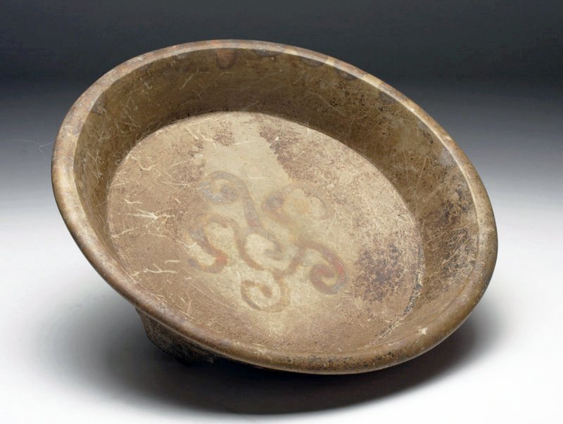 Mayan Tripod Plate from Yucatan Peninsula: Pre-Columbian, Mayan territories, Yucatan Peninsula, ca. 400 to 600 CE. Mayan brownware tripod vessel, showing distinct Teotihuacan influence with slab feet, decorated on the interior with abstract 5-