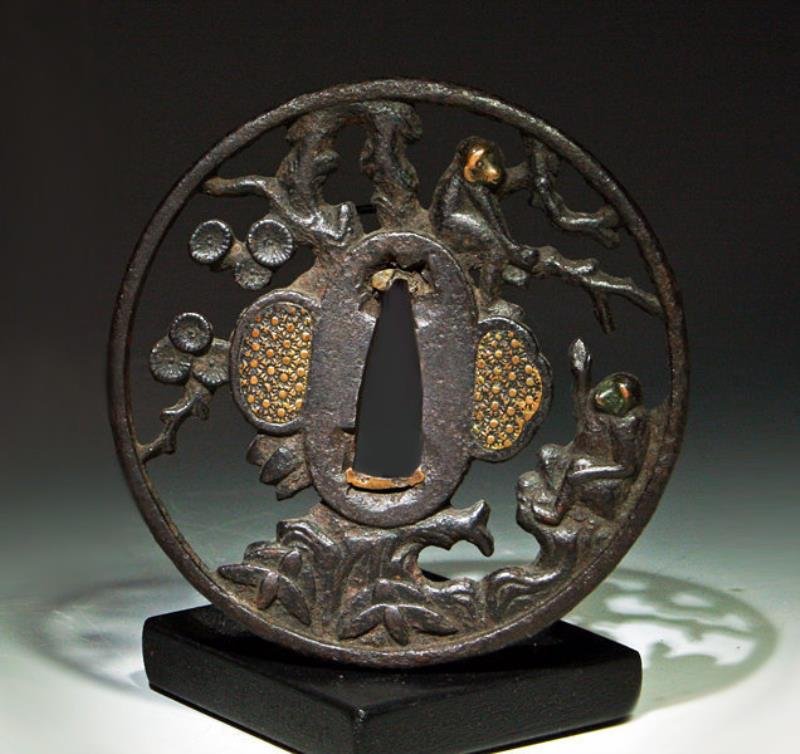 Japanese Bronze / Gilt Sword Tsuba - Monkeys: Japan, Edo Period, ca. 17th to 18th century. Beautiful round iron Nobutaka tsuba decorated with scene of two confronting monkeys among foliage, twin gilt panels on front and reverse. A tsuba is the sw