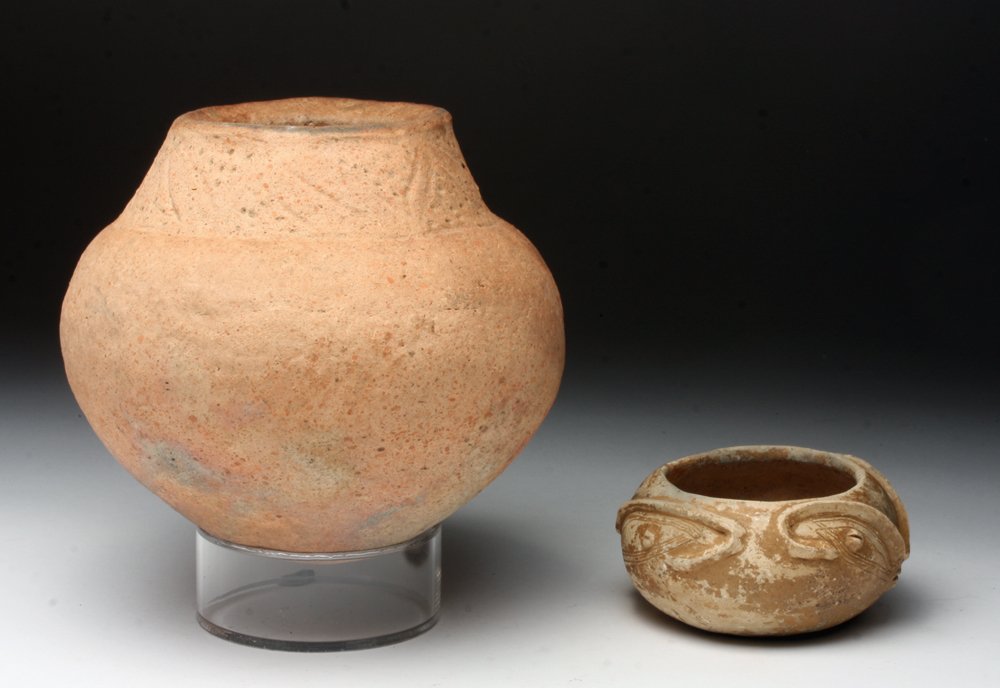 Lot of 2 Pre-Columbian Tairona Jars: Pre-Columbian, Colombia, Tairona Culture, ca. 1000-1550 CE. Two beautiful ceramic jars created by the Tairona culture of Colombia. The first is a charming face effigy vessel with coffee bean eyes, ski