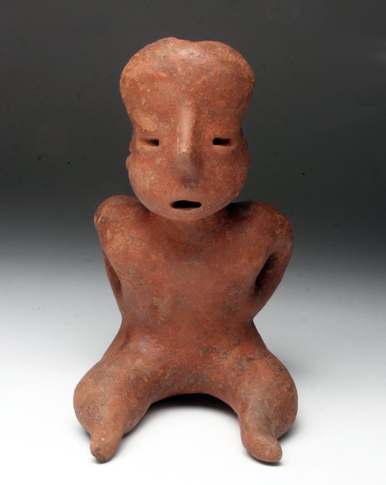 Pre-Columbian West Coast Seated Nude Figure: Pre-Columbian, West Mexico, Nayarit or Chinesco, ca. 200 CE. Red-slipped nude figure with expressive visage and gesture. Nice example from this region's shaft tomb tradition. Rather than the relativel
