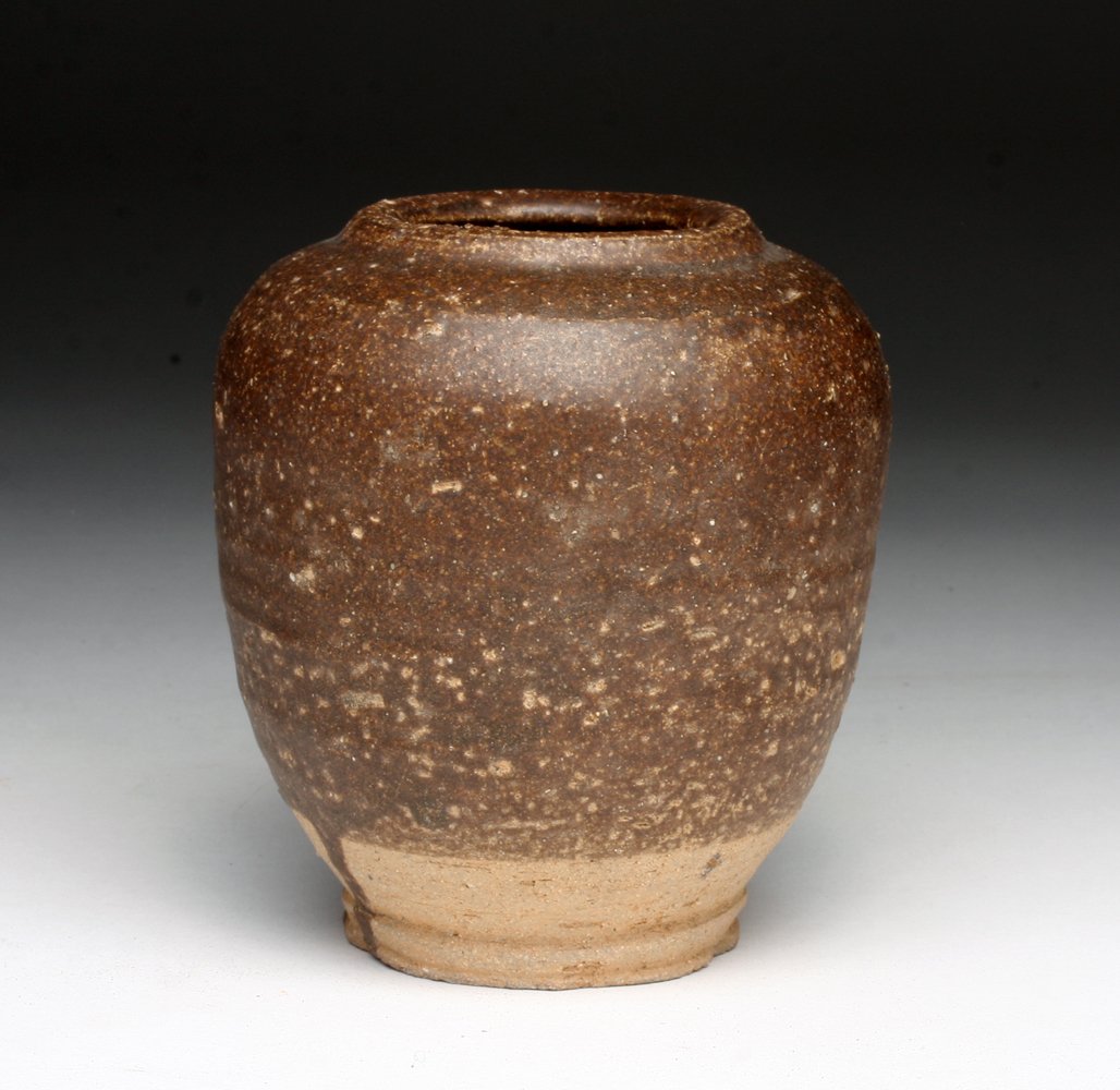 Eastern Chinese Han Dynasty Pottery Jar: "China, ca. 1st - 2nd Century CE. Terracotta jar with thick brown slip. Jar has bulbous body with low rim. Marks where vessel was held during firing on sides. 4""H. Provenance: Ex-Private California C