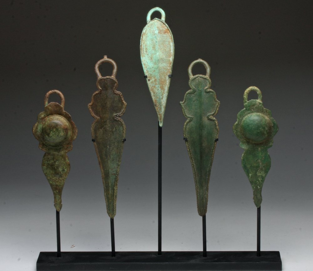 Lot of 5 Khmer Bronze Pectoral Fittings: Cambodia, ca. 12th Century CE. Set of five cast bronze breast plate pieces of various design, with two pairs of matching pieces and a single un-matching piece. Sizes vary from 6-1/2" to 8-3/4" long. C
