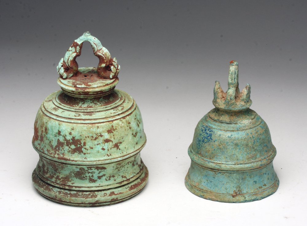 Lot of 2 Khmer Bronze Bells: Cambodia, Ca. 12th Century. Constructed in stacked style: wide bottom tapers in to the wide bottom of next level. Hanging loop is in shape of the bell and decorated with flower bursts on either side o