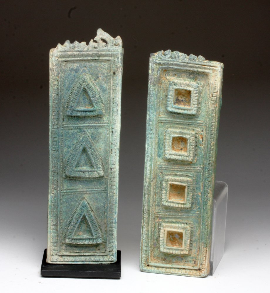 Lot of 2 Cambodian Bronze Furniture Panels: Cambodia, Khmer Period, ca. 12th - 14th century CE. Two cast bronze long panels with square and triangular patterns and floral tops. Exceptional detail! Azurite deposits on both. 8-7/8" & 9-1/8"L. Pro