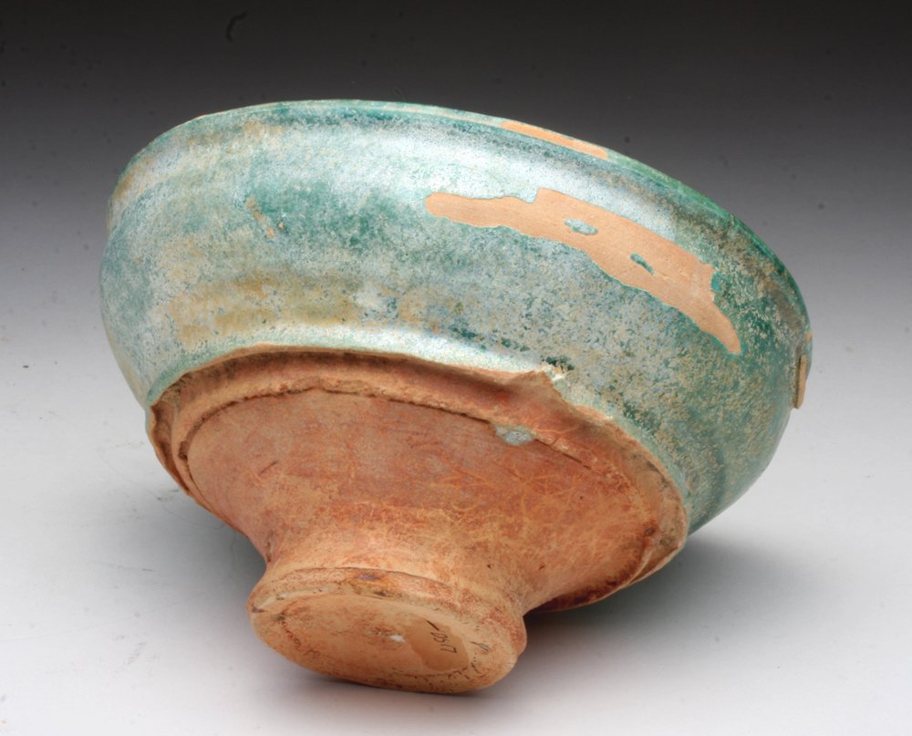 Chinese Han Dynasty Green Glazed Bowl: China, Han Dynasty, ca. 206 BCE - 220 CE. A beautiful terracotta bowl with thick green glaze with silvery iridescence, three firing marks, and unslipped pedestal. 6"D x 3-1/4"H. Provenance: Ex-private
