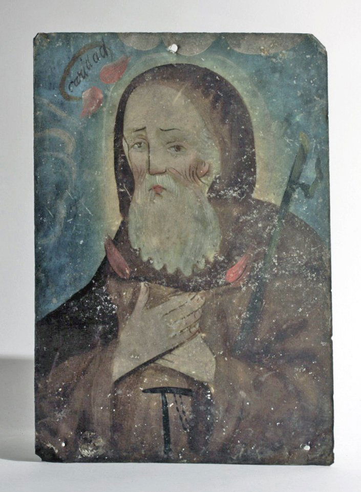 19th C. Mexican Retablo, San Francisco De Paula: Mexico, ca. 19th Century CE. An antique tin retablo depicting St. Francis of Paolo shown here wearing the simple robes of his order, his hands crossed on his chest. His face is lined with age, his bro