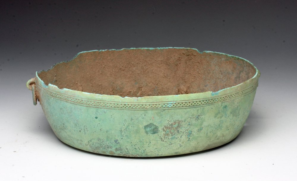 Ancient Dong Son Bronze Dish: Vietnam, Dong Son Collection, 1st millennium BCE. Incised dot pattern circles rim of jar, outside of jar has loops for handles, one handle remains. Wonderful blue-green patina. 8-1/4"W x 2 -1/4"H. Pro