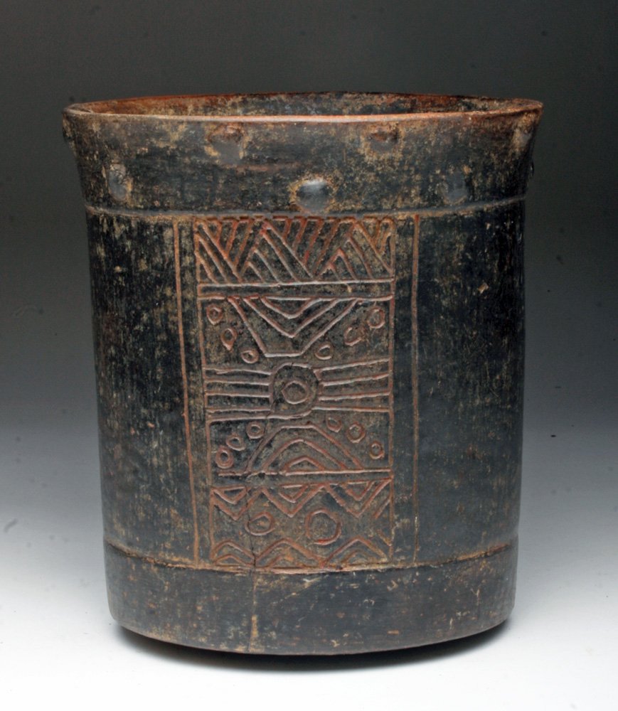 Pre-Columbian Mayan Brownware Cylinder: Mayan Territories, probably Guatemala or Honduras, ca 500 to 800 CE. Terracotta vessel with slightly flared rim, series of small nodes around upper 1" of rim, incised mat glyphs and celestial patterns