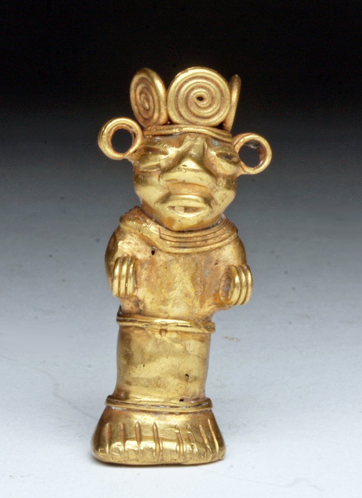 Pre-Columbian Tumbaga Standing Figure, 10.9g: Colombia, Ca 1500 CE. Tumbaga - technique of creating combining gold and copper where gold "floats" to the top allowing the creation of beautiful gold items while using a minimum of gold. Standing fig