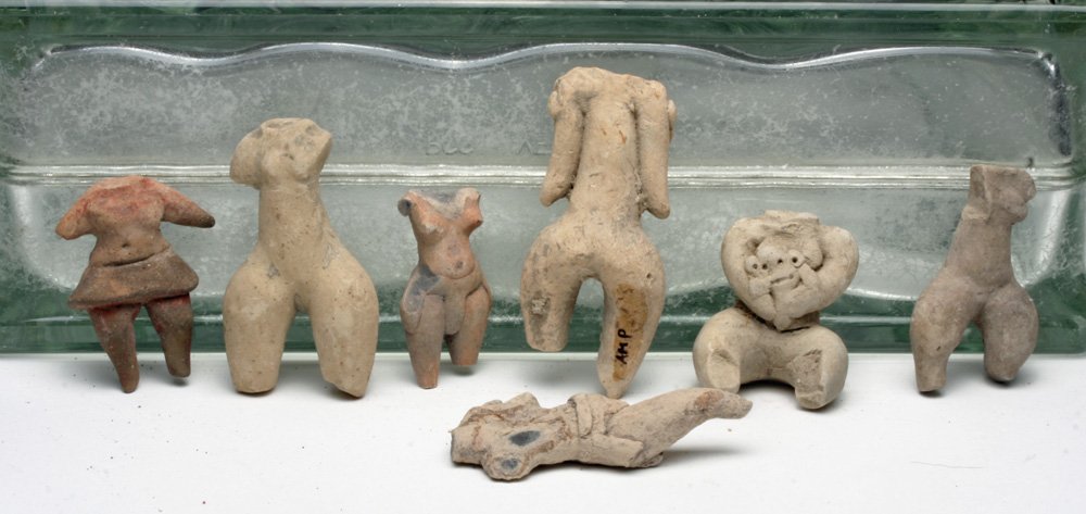 Lot of 7 Tlatilco and Proto-Mayan Female Torsos: Pre-Columbian, Tlatilco and Proto-Mayan cultures, ca. 800- 0 BCE. Variety of Tlatilco and Proto-Mayan representations of the female human form. Proto-Mayan example is holding a small figure, either hu