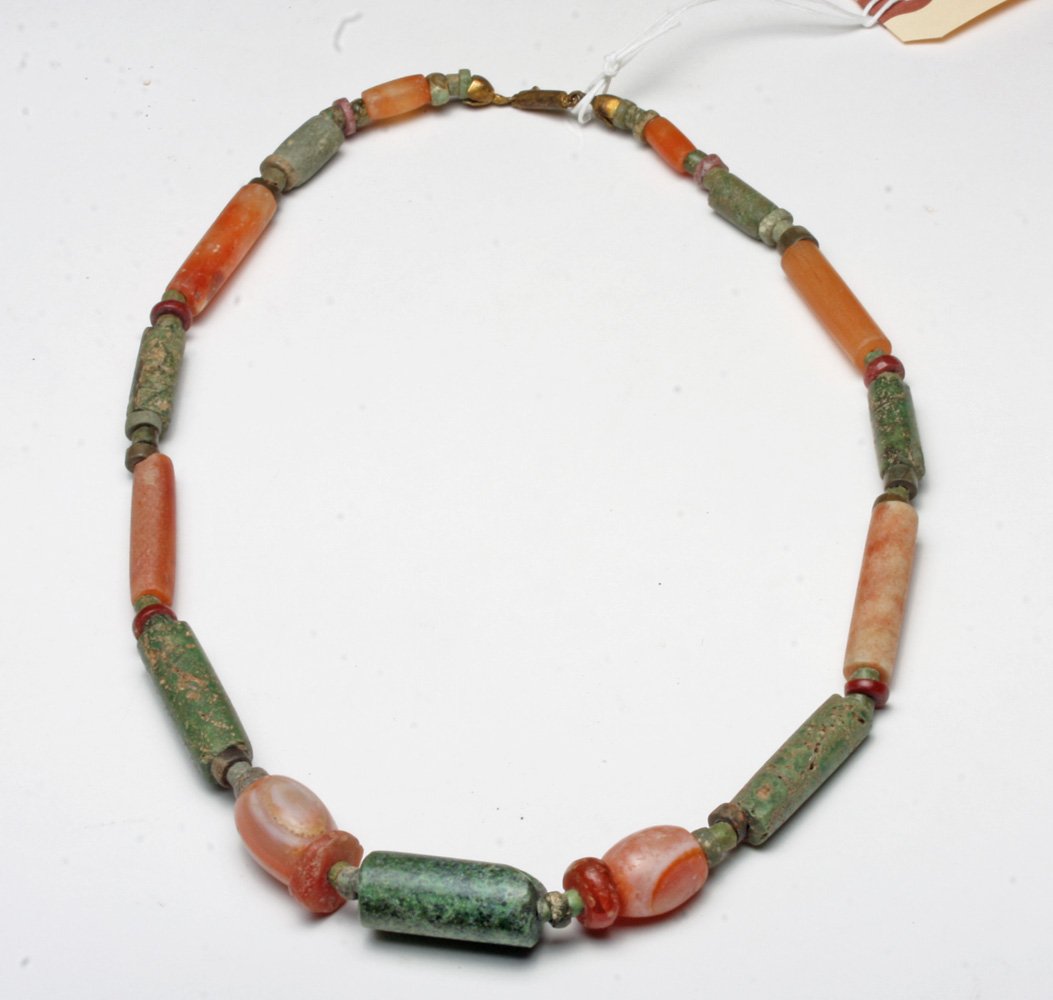Pre-Columbian Tairona Stone Necklace: Colombia, Tairona culture, ca 500-1500 CE. Beautiful necklace comprised of ancient tubular, lozenge and circular shaped stone beads - including carnelian and greenstone beads of varying hues. All are 