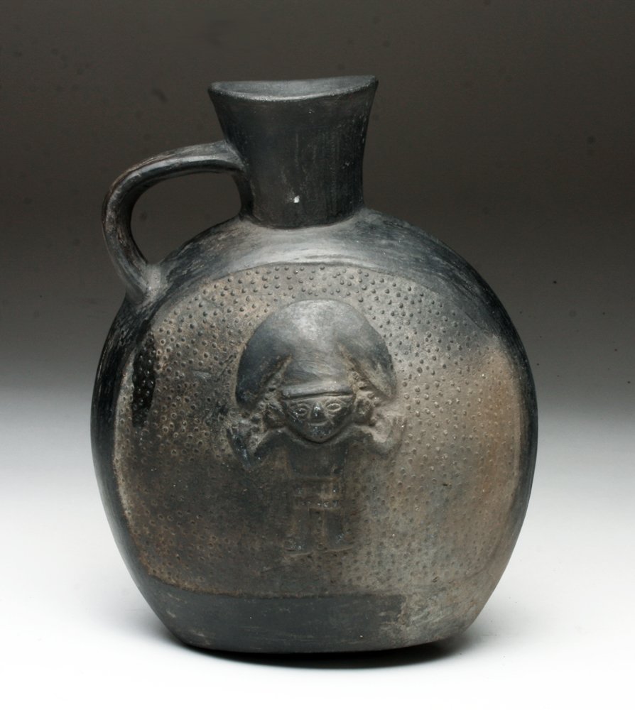 Chimu Inca Vessel - Birds and Shaman: Pre-Columbian, Peru, North Coast, Chimu, ca. 1100-1530 CE. Canteen-shaped, pressed-ware blackware pottery bottle with a wide, flaring spout, and strap handle on the shoulder. The artisan impressed the