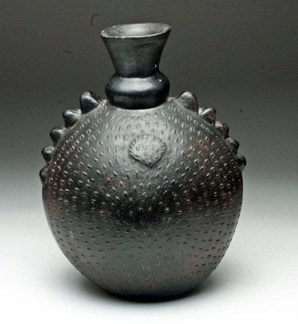 Chimu-Inca Effigy Blackware Canteen: Pre-Columbian, Peru, North Coast, Chimu-Inca culture, ca. 1470-1532 CE. Large canteen-shaped, blackware pottery vessel with a wide, flaring spout, and five suspension lugs on the shoulder of each side