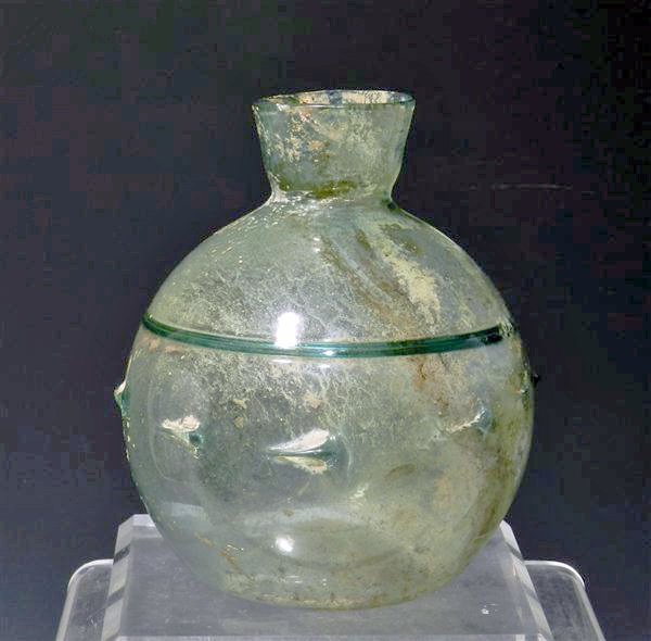 Roman Glass Flask - Banding and Pinches: Rome, ca. 3rd-4th Century CE. Pale blue/green glass with concave bottom and short funnel neck; around middle of the body is a row of horizontally-oriented raised pinches, above which is an unusual int