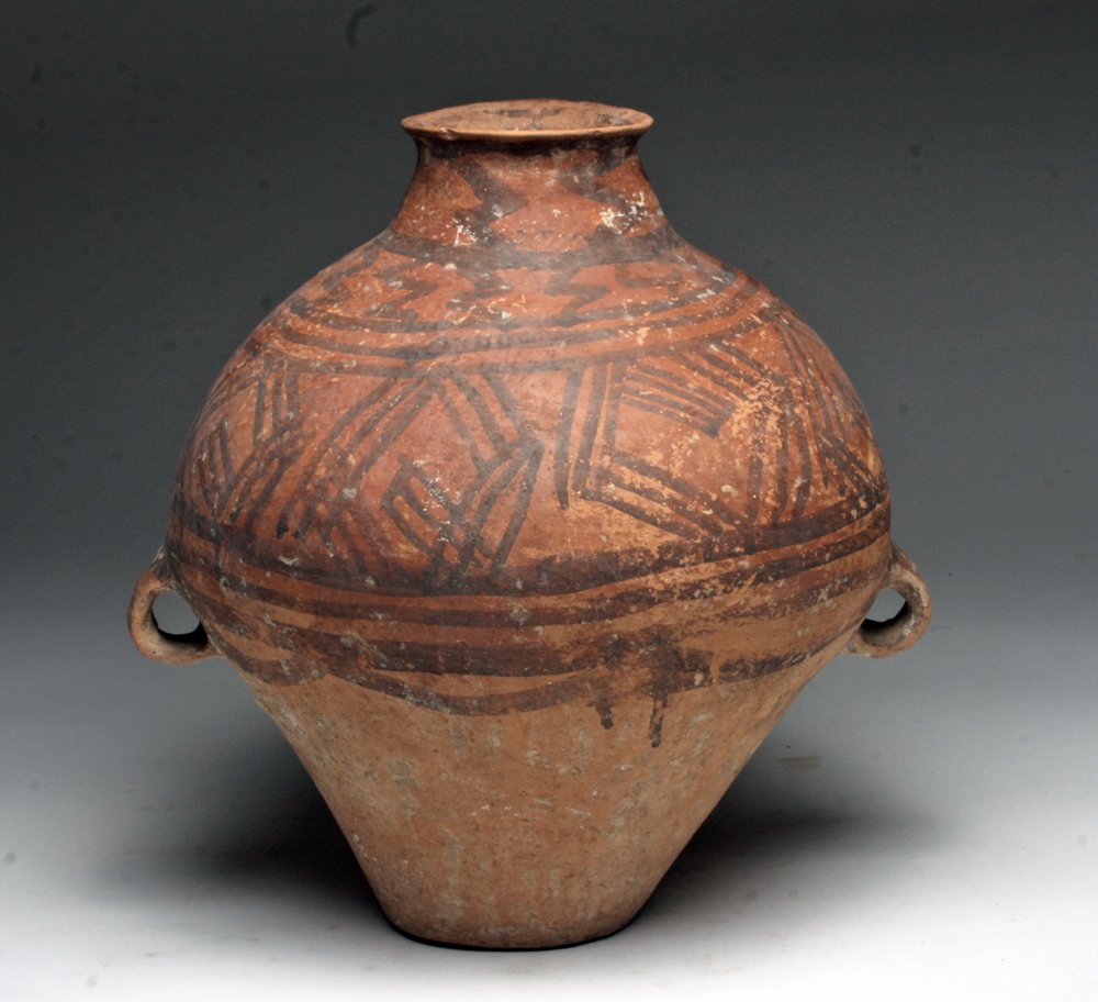 Chinese Neolithic Painted Amphora: China, Neolithic Period, Longshan Culture, ca. 3000 - 2000 BCE.. A large terracotta vessel with small loop handles on either side below the shoulder. Original red and black pigment is present around t