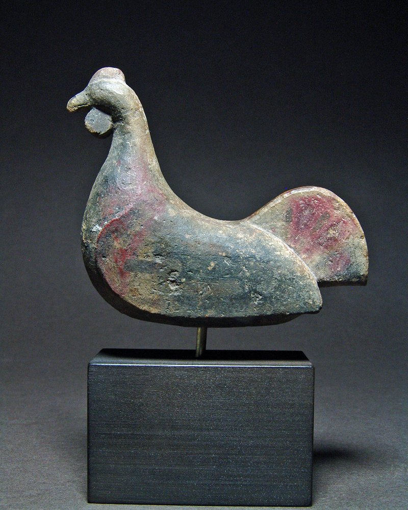 Chinese Han Dynasty Pottery Hen Figure: China, ca. 202 BCE - 220 CE. Terracotta funerary figure of a sitting hen showing traces of polychrome. Skillful modeling of the head, schematic rendition of the wings and prominent tail. Chickens and 