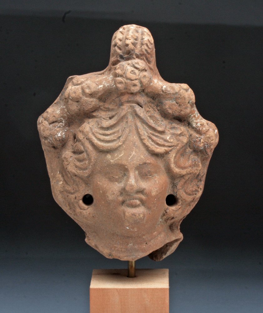 Egyptian / Alexandrian Head of Isis: Egypt, Alexandria, Ptolemaic Period, Ca 303 to 164 BCE. Finely molded pottery head of the Egyptian Goddess Isis. Isis was worshipped as the ideal mother and wife as well as the patroness of nature and