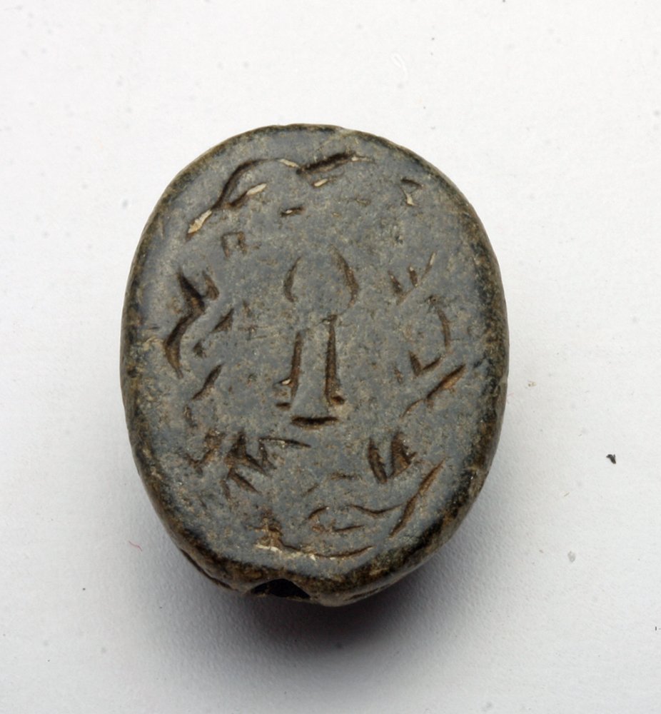 Sumerian / Mesopotamian Stamp Seal: Ancient Sumeria, Ca 1500 tp 900 BCE. Stamp seal in scaraboid form, carved from deep black stone, drilled for suspension. Image is a bit worn but includes snake, birds and central amphora. 26mm in diam