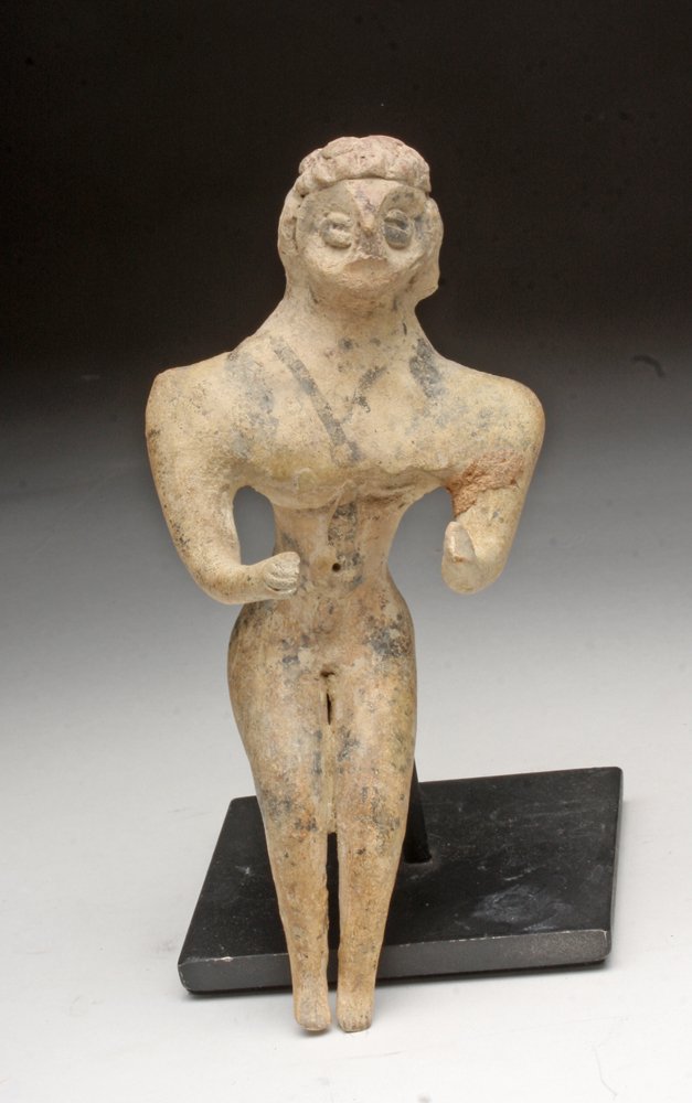 Syro-Hittite Fertility Goddess: Syria, early 2nd millennia BCE. Pottery fertility goddess with bird-like face, wide shoulders, thin waist, thin legs and arms shown in near seated position. Original black pigment on upper torso and h