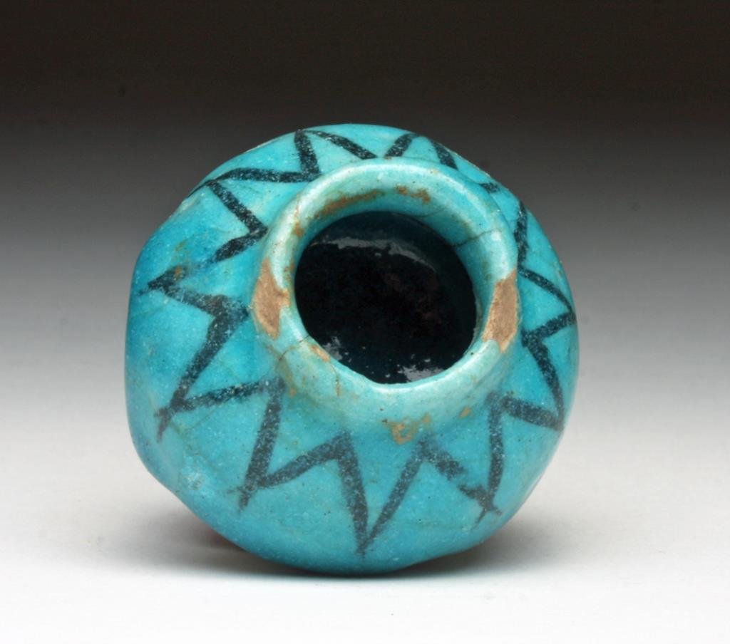 Small Islamic Blue Glazed Jar: Cute! Iran/Turkey, Ca 14th century CE. Small ceramic jar on flared foot, covered with sky blue glaze and decorated with black rigaree. 1-3/4" H. Provenance: Ex-Smith collection acquired in the 1980's.