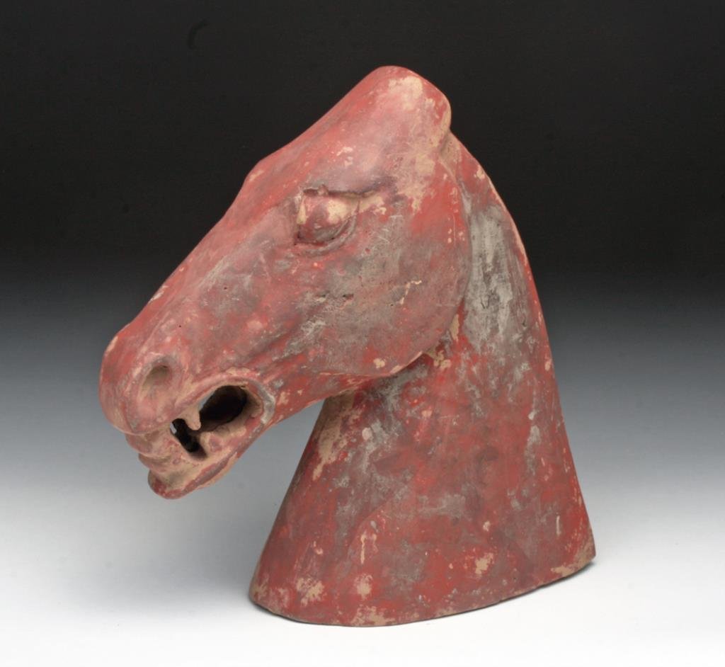 Chinese Han Dynasty Horse Head: China, Han Dynasty, Ca. 206 BCE - 220 CE. Terracotta molded horse head from statuette depicted with mouth open and head reared back. Strong jaw line and neck. Bulging eyes and gnarly teeth. A real fie