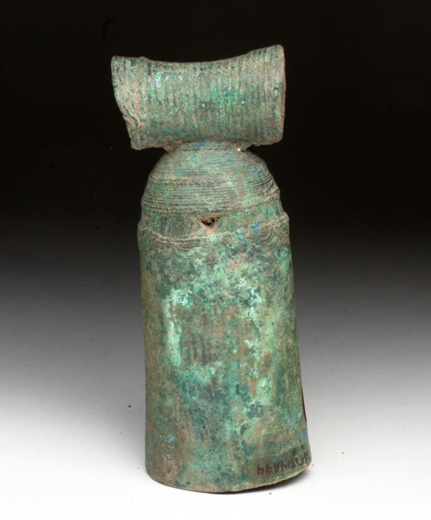 Dong Son Bronze Bell: Viet Nam, Cambodia, Ca 1st millennium BCE. Large cast bronze Bell. Long tubular bell with scroll and chevron decorations toward top, circular bale decorated with vertical incised rings. Clapper in pla