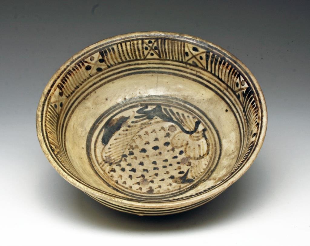 Anamese Glazed Pottery Bowl: Southeast Asia - Viet Nam to Thailand, Ca 15th to 16th century CE. Pottery bowl on short foot, decorated with geometric and floral design. 7-3/8" D. Provenance: Ex-D. Smith collection acquired in the 