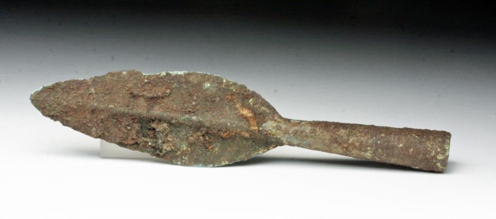 Ban Chiang Bronze Spear Head: Thailand, Ca 1st millennium BCE. Very rare! Bronze spear tip with medium length socket, leaf-shaped blade with distinct ridge down the center, now covered in light green patina and brown encrustations