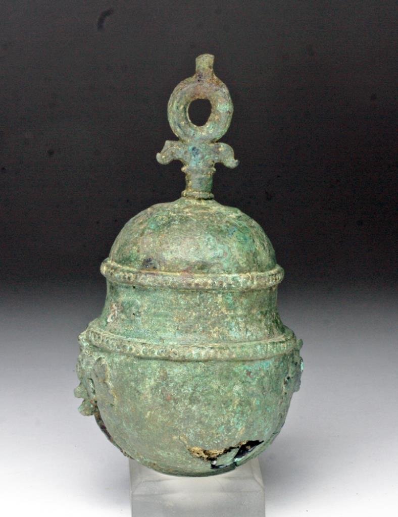 Large Khmer Bronze Bell w/ Garudas: Cambodia, 10th to 13th century. Large heavy cast bronze bell in three tiers, Garudas (Sacred birds) adorn the sides, iron clapper rusted in interior. 6" H. Provenance: Ex- Smith collection. All items 