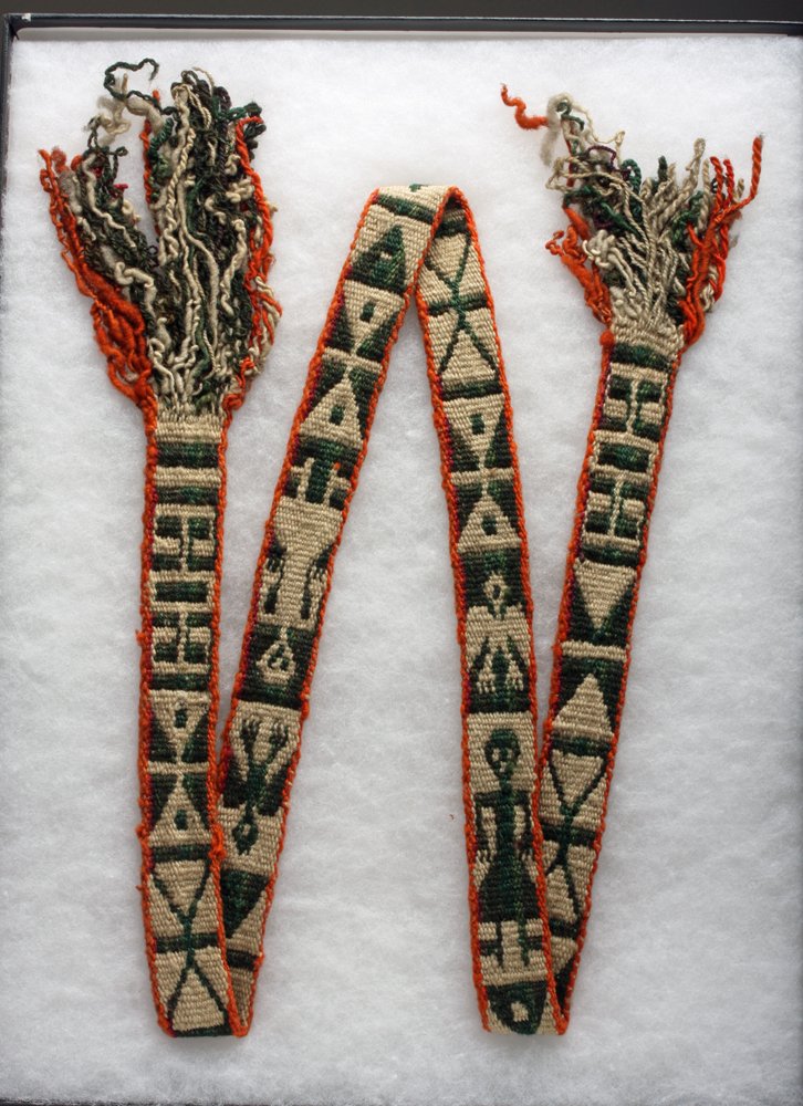 Attractive Pre-Columbian Inca Textile Sash: Central Peru, Ca 1400 to 1500 CE. A most attractive textile sash, possibly used as a headband, woven in red, green and tan camelid fibers. Scene alternates between a standing human, a bird in flight a