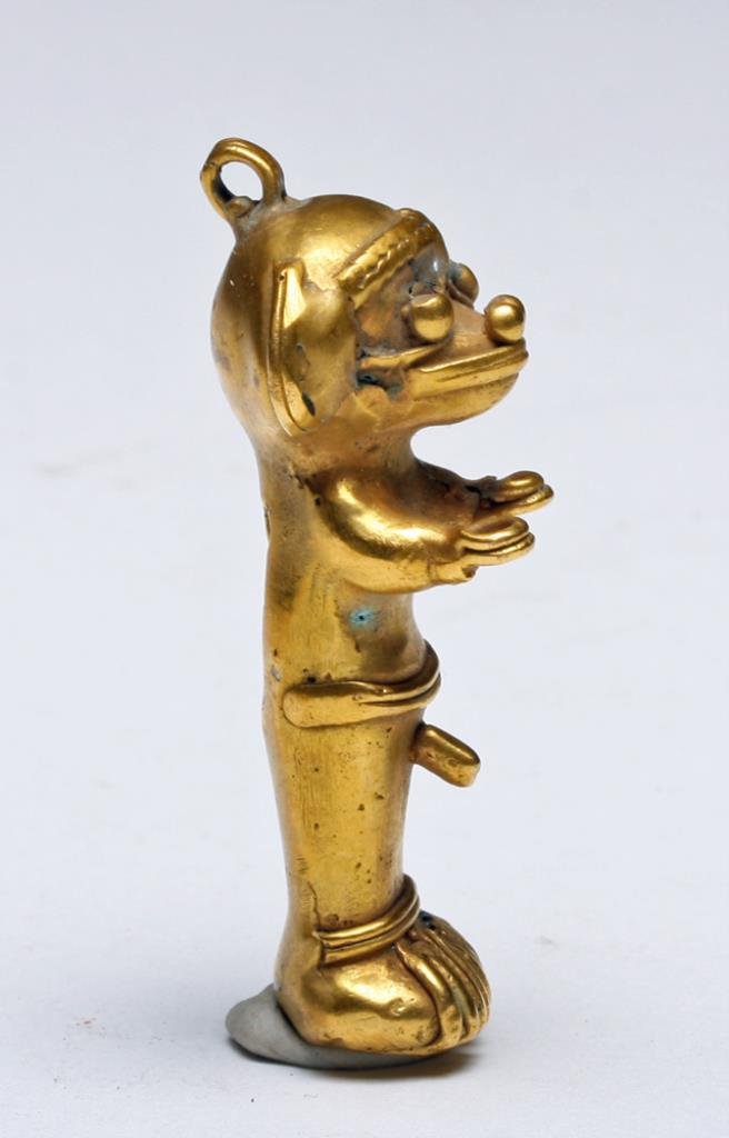 Colombian Gold Tumbaga Standing Figure: Pre-Columbian, Colombia, Ca 1500 CE. Tumbaga - technique of creating combining gold and copper where gold "floats" to the top allowing the creation of beautiful gold items while using a minimum of gol