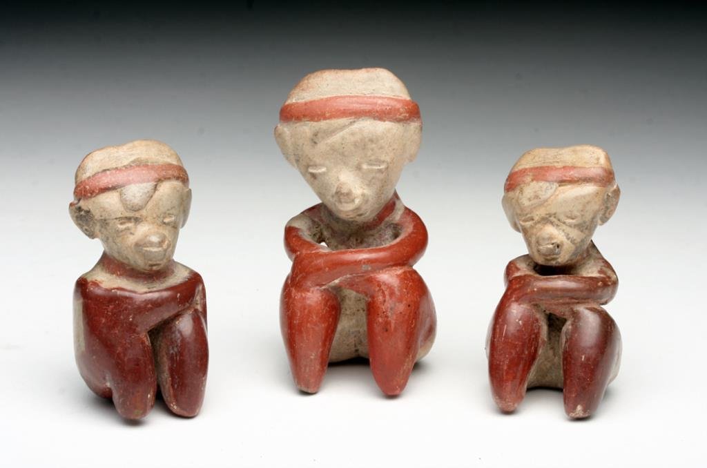 Lot of 3 Matched Miniature Chinesco Figures: Pre-Columbian, Nayarit, Mexico, Ca 200 Be to 200 CE. Very sweet set of three nearly matched pottery seated figures in the style known as Chinesco. Each with triangular head, red and white pigments, ea