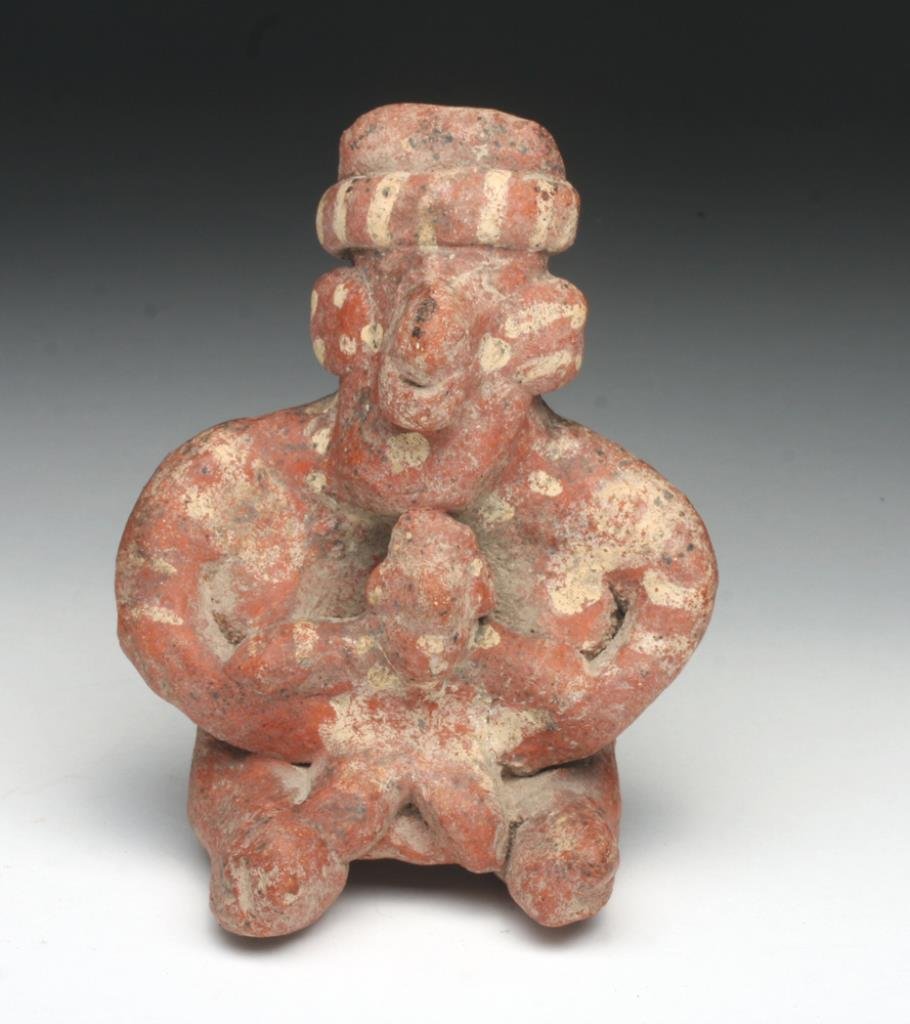 Jalisco Sheep-Face Pottery Figure: Pre-Columbian, West Mexico, Jalisco region, Ca 200 Be to 200 CE. Cute and somewhat rare pottery seated figure of a mother and child. Redware pottery decorated with added white stripes and dots, mother