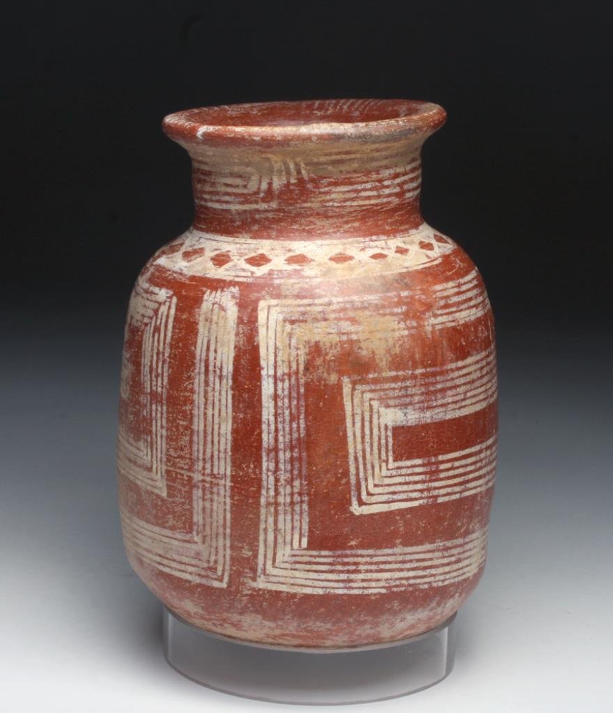 Unusual Michoacan Pottery Jar: Mexico, Michoacan area, Ca 200 to 500 CE. A fairly rare form of Michoacan pottery! Redware jar with rounded base and flaring rim, decorated with red slip over which white geometric lines and diamonds