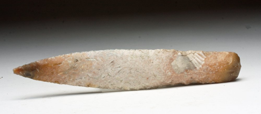 Danish Neolithic / Early Bronze Age Stone Knife: Denmark, Ca 5000 to 3000 BCE. A finely knapped dagger from what is commonly called the "dagger period." Made from a creamy chert with bifacially knapped blade and squarish butt. 6-5/8" L. Provenance: 