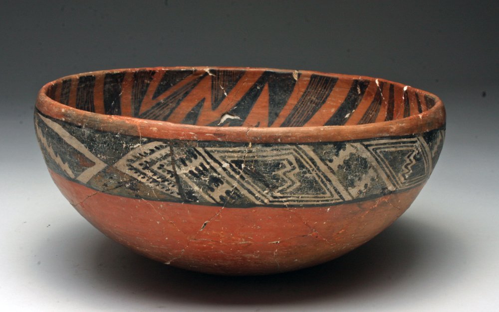 Prehistoric Anasazi Salado Redware Bowl: Arizona, New Mexico, Ca 1300 to 1350 CE. Large Native American pottery bowl in redware decorated on the exterior with black on white triangular and geometric designs, interior with lightning pattern i