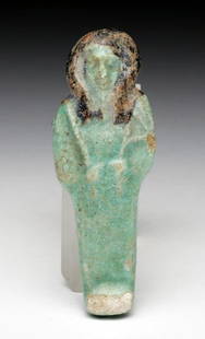 Egyptian Faience Ushabti - Third Intermediate Period: Egypt, Third Intermediate Period, Ca 1030 to 715 BCE. Light green glazed ushabti, holding crook and flail, hair in added black pigment. 3" L. Provenance: Ex-A. Carafelli Collection. All