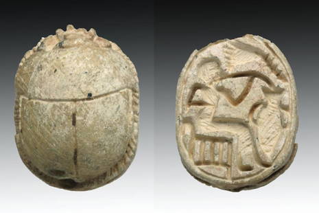 Large Steatite Scarab - Seated Isis: Egypt, New Kingdom to Third Intermediate Period, Ca 1570 to 1030 BCE. Large and well carved steatite scarab. Once glazed, mostly gone, carved on the underside with Isis, shown seated, holding what