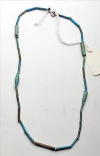 Egyptian Faience Necklace: Egypt, Third Intermediate Period, Ca 1030 to 715 BCE. Necklace comprised of multiple faience beads in shades ranging from light blue to green/brown. Four of the beads are a more unusual heavy thick