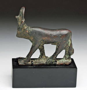 Egyptian Bronze Apis Bull, Ex-Sothebys: Egypt, Late Dynastic Period, Ca 662 to 330 BCE. Cast bronze Apis bull on integral plinth, shown wearing solar disc and uraeus. 2-7/8" L by 2-3/4" H, not including custom base. Provenance: