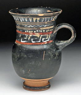 Greek Apulian Gnathian Pottery Mug: Apulia, Ca 340 to 325 BCE, found near the town of Ignazia (hence term Gnathian). Fine pottery mug decorated in added red, tan and white pigments in geometric patterns, small ringed handle. 4-5/8" H.