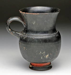 Greek Campanian Ribbed Mug: Campania, southwestern Italy, Ca 350 BCE. A superb pottery mug on short foot, ribbed exterior, flaring rim and small loop handle. Exquisite surface and patina! 4-1/8" H. PROVENANCE: EX- M. Bier