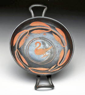 Greek Apulian Xenon Swan Kylix: Apulia, Ca 340 to 325 BCE. Beautiful pottery kylix - wine cup - on low foot, shallow bowl, twin up-sloaping handles, decorated in Xenon technique with swan in center laurel leaves surrounding and on