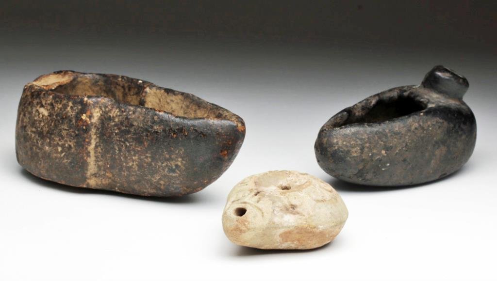 Lot of 3 Ancient Oil Lamps: Holy Land and Europe, Ca 300 CE and 1000 CE. First, pottery oil lamp from the Holy land. In a style similar to the Egyptian frog lamp, with impressed designs overall including makers mark on base, 3-1
